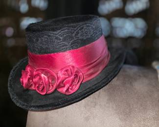 


This item is an Elope Gothic Rose Top Hat, a black velvet costume hat featuring a crimson satin band, black lace overlay, and matching red satin roses. 