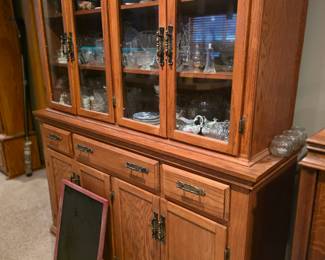 oak china cabinet appears to be a model similar to those produced by Richardson Brothers furniture. 