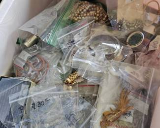 A table full of costume jewelry as well as odds and ens