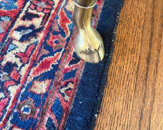 Close up the hooved feet on the La Barge round table.