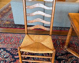 A close up of one of the side chairs. The color matches the dining table. The sun makes them appear different in this photo. 