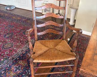 Close-up of one of the captains chairs.  Ladderback with rush seats.  