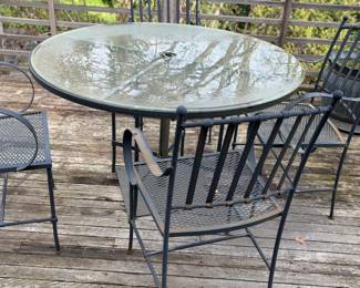 $340. Iron table with glass top and chairs. 48 1/2 inches in diameter by 30 1/2 inches high.