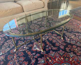 $480 Vintage 1960's La Barge oval glass top on brass base cocktail table. It is 51.5 inches wide by 26 inches deep by 17 inches high. Hooved feet close up follows.