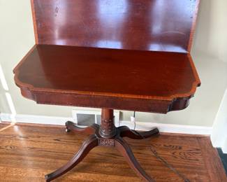 A view of the table with the top  up.  Pull it away from the wall spinning, and it opens into a game table.