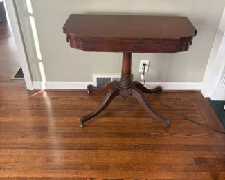 $220. Antique mahogany game table. Table top flips up and swivels to make it a game table that is 35 inches sq.  As seen it is 34 inches wide by 17 inches deep by 30 inches high.