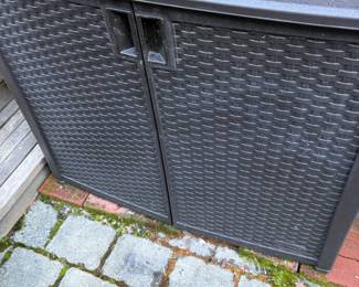 Outdoor wicker storage cabinet. 22 1/2 inches deep by 41 inches wide by 35 1/4 inches high.