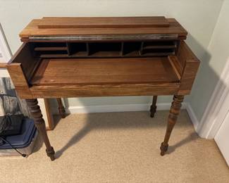 $130. Antique desk with the top that folds down to keep your work hidden. Work surface slides out .  36 inches wide by 20 inches deep by 33 inches high.