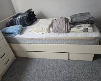 Twin laminate bed with slide out storage drawer