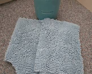 Bath rugs and ceramic wastebasket