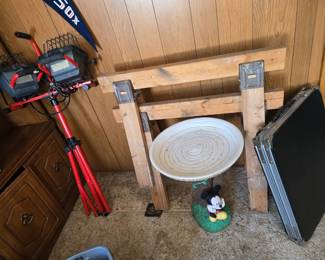 Work light, sawhorses, Mickey Mouse bird bath, small folding table