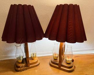 Pair of vintage wood table lamps with hurricane glass and pleated shades. Classic 1970s–80s style with electric flickering flame bulbs. Great for cabin, farmhouse, or traditional décor.