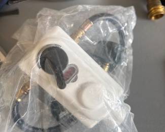 RV dual-tank propane auto-changeover regulator with pigtails. New in package, ready for travel trailer or fifth wheel installation