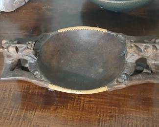 Indigenous serving dish hand carved from a single piece of solid Teak. Adorned with seated beast characters, and woven rattan edge trim. 15x8x5. $60.
