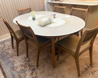 . . . mid-century modern table and six chairs