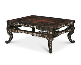 425 A Japanese inlaid ebonized wood table 20th century The tabletop pedestal inlaid with mother of pearl floral motifs, the top painted with scrolling foliate and geometric motifs centered by a floral medallion 9.5" H x 22.5" W x 18.25" D Estimate: $1,200 - $1,800