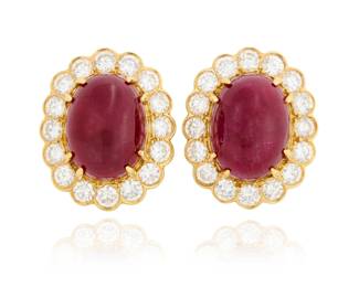 55 A Pair of 18K Gold, Ruby and Diamond Earclips Centering two oval ruby cabochons weighing approximately 14.80 and 15.05 carats, encircled by round diamonds weighing approximately 4.80 carats total 2 pieces  Measures: 7/8 x 1/2 in. 17.8 grams gross Estimate: $2,500 - $3,500