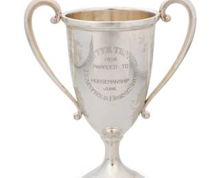 270 An Edwardian sterling silver two handled trophy cup 1905, retailed by Tiffany & Co. With hallmarks for sterling, London, date, and truncated maker's mark: G; impressed: MADE IN ENGLAND FOR TIFFANY & CO. 7" H x 9.875" W x 5.625" D 35.9 oz. troy approximately Estimate: $1,000 - $1,500