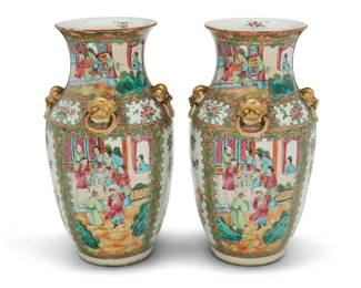 324 A pair of Chinese Export Rose Medallion porcelain vases 20th century Unmarked Each with four gilt lion-form ring handles to shoulder, painted with alternating friezes of courtly figures and birds with butterflies 2 pieces Each: 13.75" H x 7.5" Dia. Estimate: $400 - $600