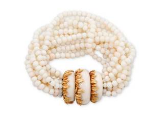 18 An 18K Gold and Coral Bracelet Featuring twelve strands of coral beads measuring approximately 5.20 mm, finished with a gold foliate design clasp accented by three domed coral cabochons, with French assay marks  Measures: 8 3/4 141.6 grams gross Estimate: $2,500 - $3,500