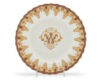 428 A set of eleven Copeland's for Tiffany & Co. porcelain plates Late 19th century Each stamped: Tiffany & Co. / New York; with blue underglaze stamp: Copeland's China Each gilt and enameled, with central monogram 11 pieces Each: 10" Dia. Estimate: $600 - $800