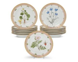 420 A set of thirteen Royal Copenhagen porcelain 'Flora Danica' style salad plates Late 20th century Each with green printed factory mark above underglaze blue wave and painted titles in Latin In the Flora Danica style, outside decorated with single cancellation 13 pieces Each: 7.75" Dia. Estimate: $400 - $600