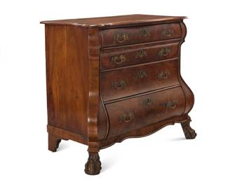 421 A Dutch walnut bombé commode 19th century With shaped front and four locking drawers, raised on paw feet 34.25" H x 41" H x 22" D Estimate: $700 - $900