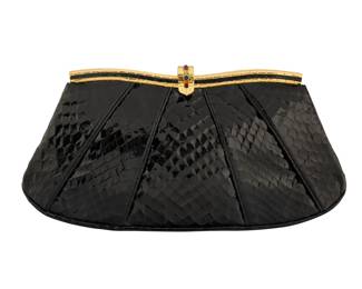 142 Judith Leiber: A Black Exotic Leather Clutch with Gemstones Marked to interior plaque: Judith Leiber / © A vintage black snake leather tapered pleated purse with a gold-toned curved frame and a golden clasp featuring multiple set gemstone and glass cabochons, with a drop-in chain strap and a tonal grosgrain lining, with one zip pocket  4 3/4 in. H x 9 1/2 in. W x 1 3/4 in. D; strap drop: 20 in. Estimate: $200 - $400