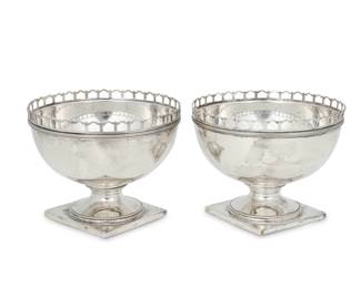 195 A pair of J. E. Caldwell sterling silver footed bowls 20th century Each impressed for maker and: STERLING SILVER / Reproduction / 278 Each with pierced galleried edge, raised on circular foot and square base 2 pieces Each: 4.5" H x 6" Dia. Total weight: 22.3 oz. troy approximately Estimate: $700 - $900