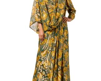 130 Nolan Miller: A Floral & Metallic Thread Evening Dress Ensemble Circa 1980s-1990s Label: Nolan Miller Couture A bustier evening gown in floaty gold, green and yellow paisley floral patterned silk and 'Lurex' fabric, featuring a gathered wrapped lightly boned and padded bodice and a draped, gathered front wrap skirt, fully lined in dark green silk, with a back zip, and with a matching one-sleeve shoulder wrap stole 2 pieces  Dress: no size label: bust across front: 18 1/2 in.; waist: 15 in.; hips: 22 in.; CB length: 51.5 un. Wrap: 100 in. x 35 in. Estimate: $100 - $200