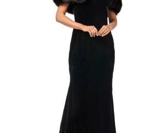 122 Oscar de la Renta: A Black Velvet & Fur Evening Gown Circa 1980s, USA Label: Oscar de la Renta A long fitted velvet dress with sweetheart neckline and off-the-shoulder sleeves with wide black fox fur collar, attached with large fur snaps to gown exterior neck edge, and with a fitted flared slight fishtail skirt and side back zipper  Size 12: bust across front: 19 in.; waist: 16 in.; hips: 21 in.; sleeves: 6 in.; CB length: 58 in. Estimate: $1,000 - $1,500