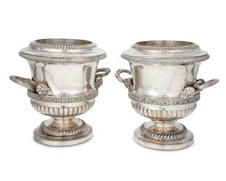 191 A pair of Sheffield silver plated footed wine coolers 19th century Each variously impressed: 2 / 4 Each with opposed vine-form handles with grapes at the terminals, gadrooning, and palmette trim, the rim and inner lining removeable 2 pieces Each: 9.125" H x 10" W x 8.125" D Estimate: $800 - $1,200