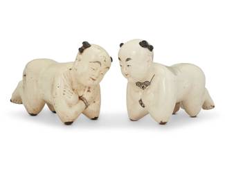 424 Two Chinese Cizhou style porcelain kneeling child pillows 19th century 2 pieces Each: 8.5" H x 15.5" W x Each: 5.5" D approximately Estimate: $300 - $500