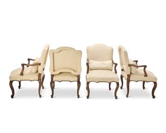 422 A set of four Louis XV style walnut armchairs Late 19th/early 20th century Each with scrolled armrest terminals and feet, upholstered in a cream herringbone fabric 4 pieces Each: 41.5" H x 25" W x 30.5" D Estimate: $800 - $1,200