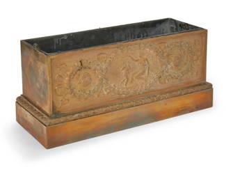 388 A French gilt bronze jardinière Late 19th century One side with a frieze depicting classical figures surrounded by wreaths and ribbons in relief, with a metal insert 5.5" H x 11.5" W x 4.5" D Estimate: $300 - $500