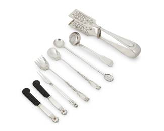 188 A group of silver serving utensils 20th century Six works:  A Georg Jensen sterling silver 'Acorn' olive fork and two horn blade caviar knives Each with impressed factory marks Fork: 6.625" L; Each caviar: 5.75" L 3 pieces  A Frank M. Whiting sterling silver 'Josephine' sardine fork and spoon Impressed factory marks and: Sterling Each: 8.125" L 2 pieces  A pair of .800 silver asparagus tongs Impressed: J.C.K. [Josef Carl Klinkosch] / 800 / [toucan mark with W and 4] 10.12" L  A Cartier sterling cocktail spoon Impressed factory marks and: Sterling 9.25" L  Together with a silver-plated small gravy ladle 6.625" L  8 pieces total Total weighable silver: 11.9 oz. troy approximately Estimate: $400 - $600