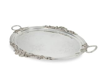 265 A WMF silver plated handled serving tray Early/mid-20th century With ostrich mark within a dashed arch for French export: WMF / G, further marked: I/O / [export star] Mounted with four foliate-form accents to handles and rim, the center further chased with foliate motifs 2.25" H x 30.875" W x 23.5" D Estimate: $400 - $600