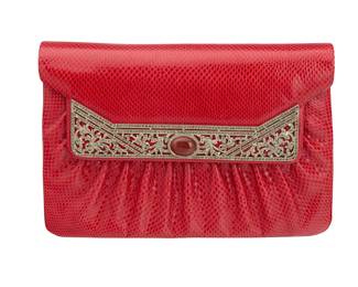 144 Judith Leiber: A Red Exotic Leather Clutch Bag Marked to interior plaque: Judith Leiber / © A vintage red pleated karung snake leather envelope purse with an Art Deco-style rhinestone and carnelian cabochon clasp and silver-toned metal hardware, with a detachable red tasseled cord strap, tonal satin fabric lining, as well as a silver compact, and a silver comb with tassel  5 1/2 in. H x 8 3/8 in. W x 2 in. D; drop: 21 1/2 in. Estimate: $200 - $400