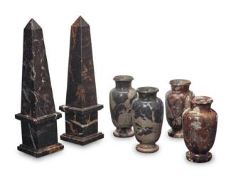 338 A group of Grand Tour style carved marble obelisks and vases Late 20th century Comprising two obelisks and two pairs of urn-form vases 6 pieces Each obelisk: 15.875" H x 4.125" W x 4.125" D; Each vase: 7.25" H x 3.75" Dia. Estimate: $700 - $900
