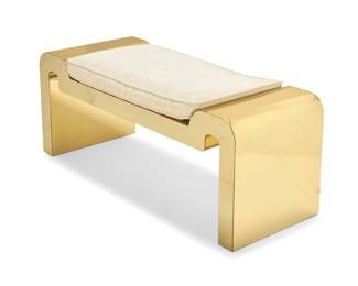 224 A Karl Springer style bench Late 20th century The metal-clad wood frame with gold-toned finish, with an inset seat cushion upholstered in a cream moiré fabric 19.5" H x 48" W x 18.125" D Estimate: $800 - $1,200