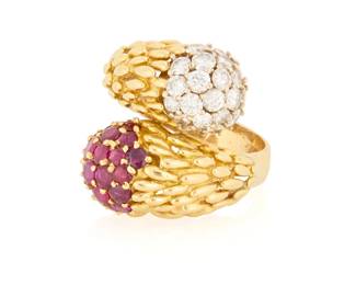 54 An 18K Gold, Ruby and Diamond Ring Of a bypass design featuring textured gold elements finished with round rubies and diamonds  Size: 7 3/4 15.0 grams gross Estimate: $2,500 - $3,500