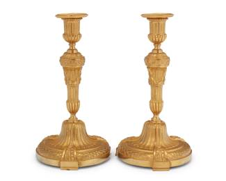 349 A pair of French gilt bronze candlesticks 20th century Unmarked Each fluted standard with laurel swags and removeable bobèche 2 pieces Each: 10.25" H x 5.375" Dia. Estimate: $300 - $500
