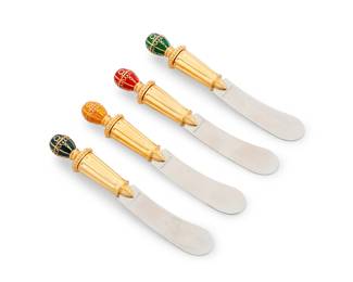 214 A set of four Fabergé 24K gold plated 'Imperial Collection' butter knives Mid/late 20th century Each marked to stainless blade: FABERGE Each with enameled egg fitted with a cut crystal accent, housed in original felt-lined box 4 pieces Each: 4.75" L; Box: 2.25" H x 5.75" W x 6.25" D Estimate: $300 - $500