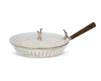 196 A Cartier sterling silver silent butler 20th century Impressed: CARTIER / STERLING / 925/000 The circular dish with hinged lid surmounted by a squirrel finial and thumbpiece, with wood handle 3.375" H x 12.75" W x 7.75" D 15.5 gross oz. troy approximately Estimate: $400 - $600