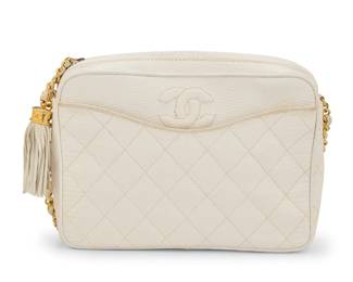 152 CHANEL: A Quilted White Lizard Leather CC Pocket Camera Bag Circa 1980s; Italy Stamped to interior: Chanel / ® / Made in Italy; with early tag to pocket interior: 404680 A vintage rectangular exotic leather crossbody bag with shaped exterior pocket, small fringe CC tassel, gold tone hardware, leather chain strap, and zip closure, and with tonal smooth leather interior and one zip pocket with satin lining  6 1/2 in. H x 9 in. W x 2 1/4 in. D; strap drop: 17 1/2 in. Estimate: $600 - $800