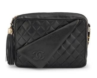 149 CHANEL: A Black Quilted Leather CC Collar Camera Bag Circa 1980s-1990s; Italy Stamped to interior: Chanel / ® / Made in Italy A rectangular soft leather bag with large fringe CC tassel, CC folded collar detail to front pocket, gold tone hardware, leather chain strap and zip closure, and with black smooth leather interior and one zip pocket with CC charm  7 1/2 in. H x 10 in. W x 2 1/2 in. D; strap drop: 20 in. Estimate: $700 - $900