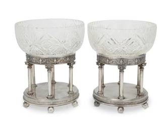 190 A pair of British Neoclassical style silver plated and cut glass center bowls Late 19th century Glass bowls etched: MADE IN / Edinburgh / SCOTLAND; stand impressed 2 or 4, each with British registration mark, one mark is partial Each cut glass deep bowl raised on a circular portico stand on ball feet 2 pieces Each stand: 5.625" H x 6" Dia.; Each bowl: 3.375" H x 7" Dia.; Each overall: 8.5" H Estimate: $300 - $500