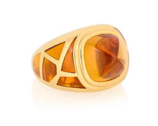 4 An 18K Gold and Citrine Ring Centering a sugarloaf citrine accented by geometric gold openwork filled with orange accents, with French assay and makers marks  Size: 7 3/4 13.1 grams gross Estimate: $3,000 - $5,000
