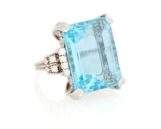 31 A Platinum, Aquamarine and Diamond Ring Centering an emerald-cut aquamarine weighing approximately 31.27 carats, accented by twelve round diamonds  Size: 8 21.1 grams gross Estimate: $3,000 - $5,000