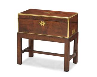 431 A Victorian brass bound rosewood lap desk Mid-19th century Inscribed to metal plaque: Presented to / Mr. Robert Stewart / Inland Revenue Officer / by the / Members of the Total Abstinence Society / Maybole 1852 With opposed carrying handles and locking hinged top, opening to reveal a hinged gilt-stamped leather writing surface and stationery storage with three drawers and a pen rest, raised on a later wood stand Closed: 7.75" H x 19.875" W x 10.875" D; Stand: 12.625" H x 20.375" W x 11.25" D Estimate: $500 - $700